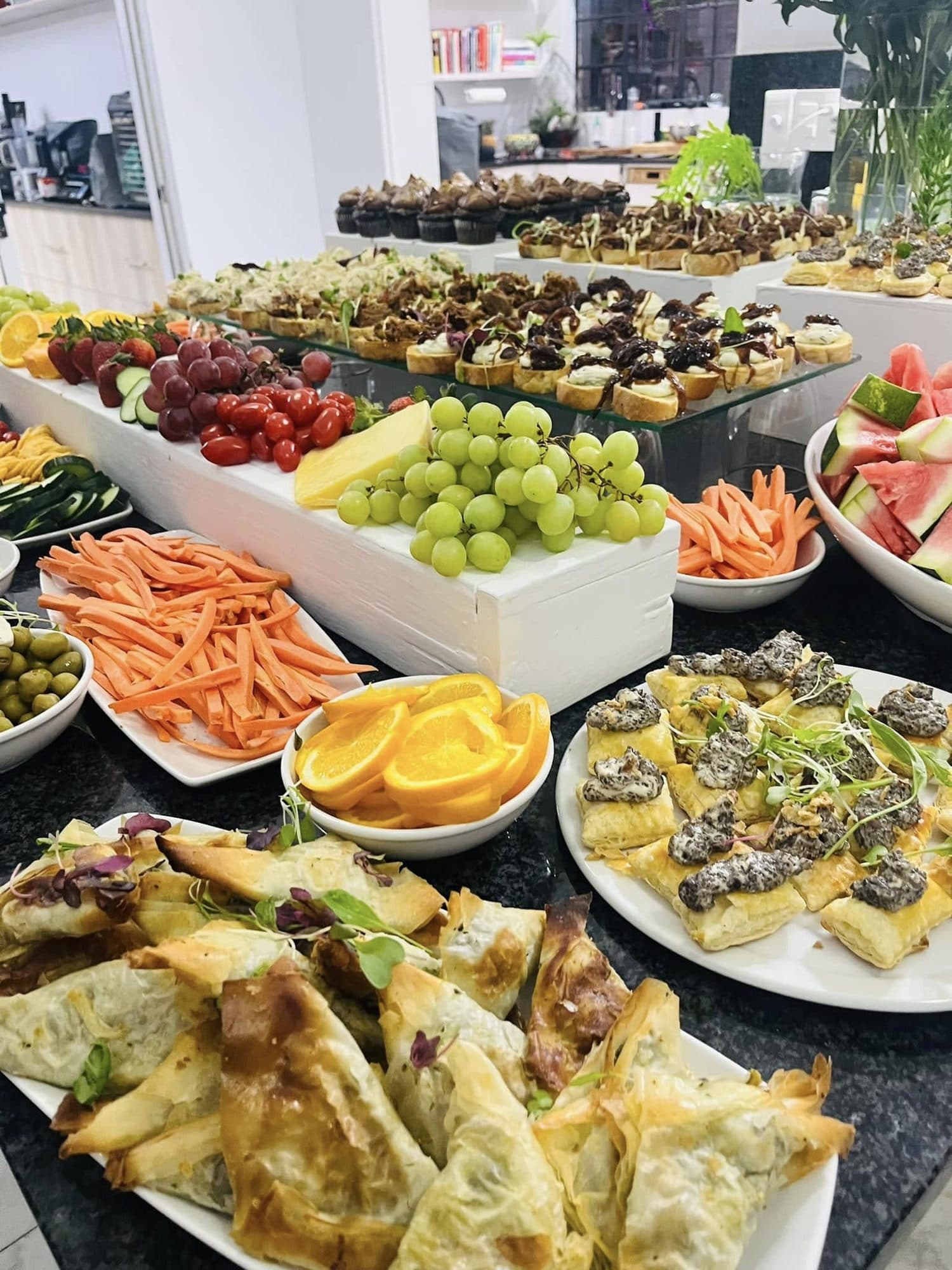 Buffet table of fruit, pastries and savoury bakes