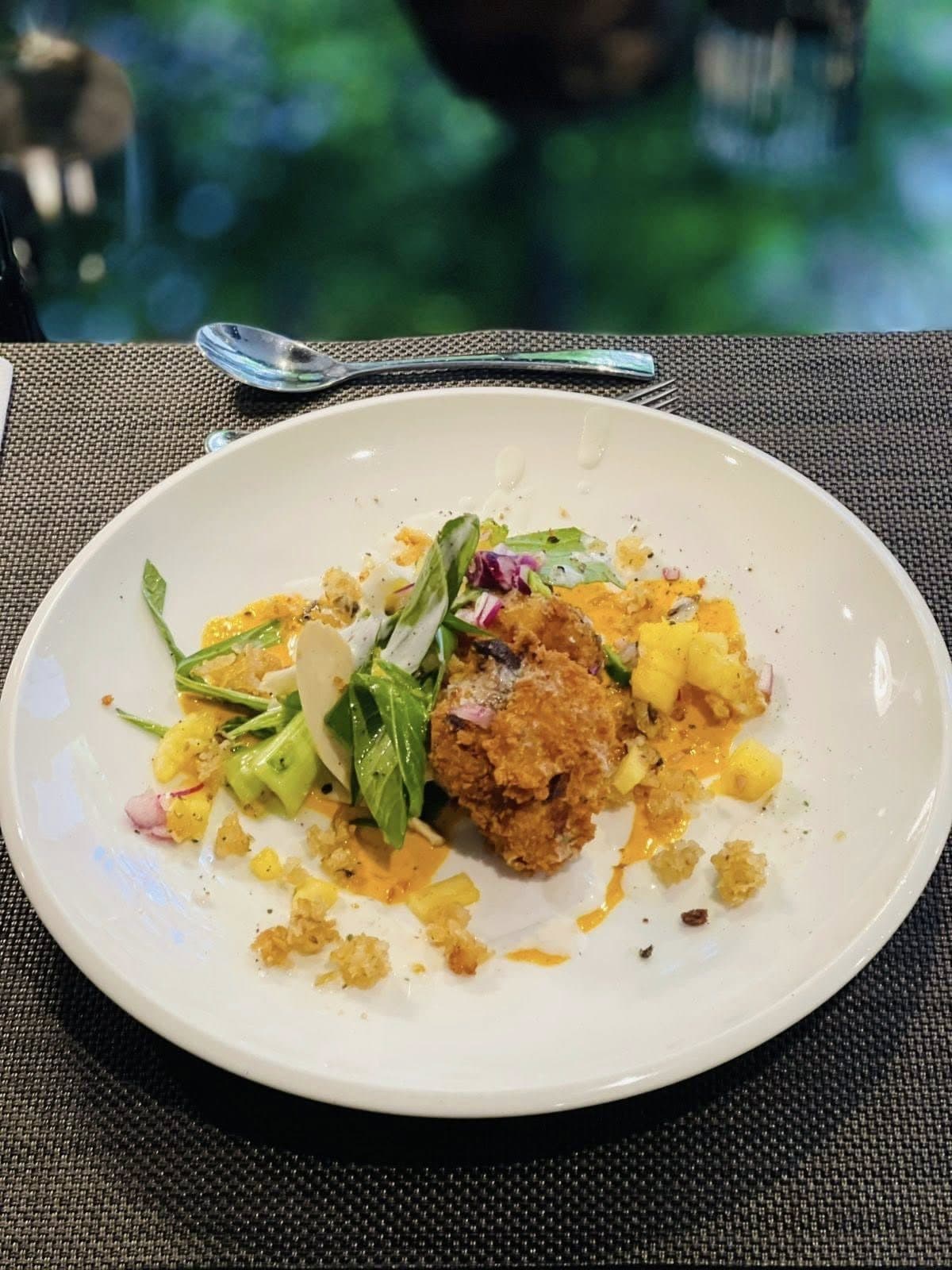 Colourful plated main with crisp garnish and fresh vegetables