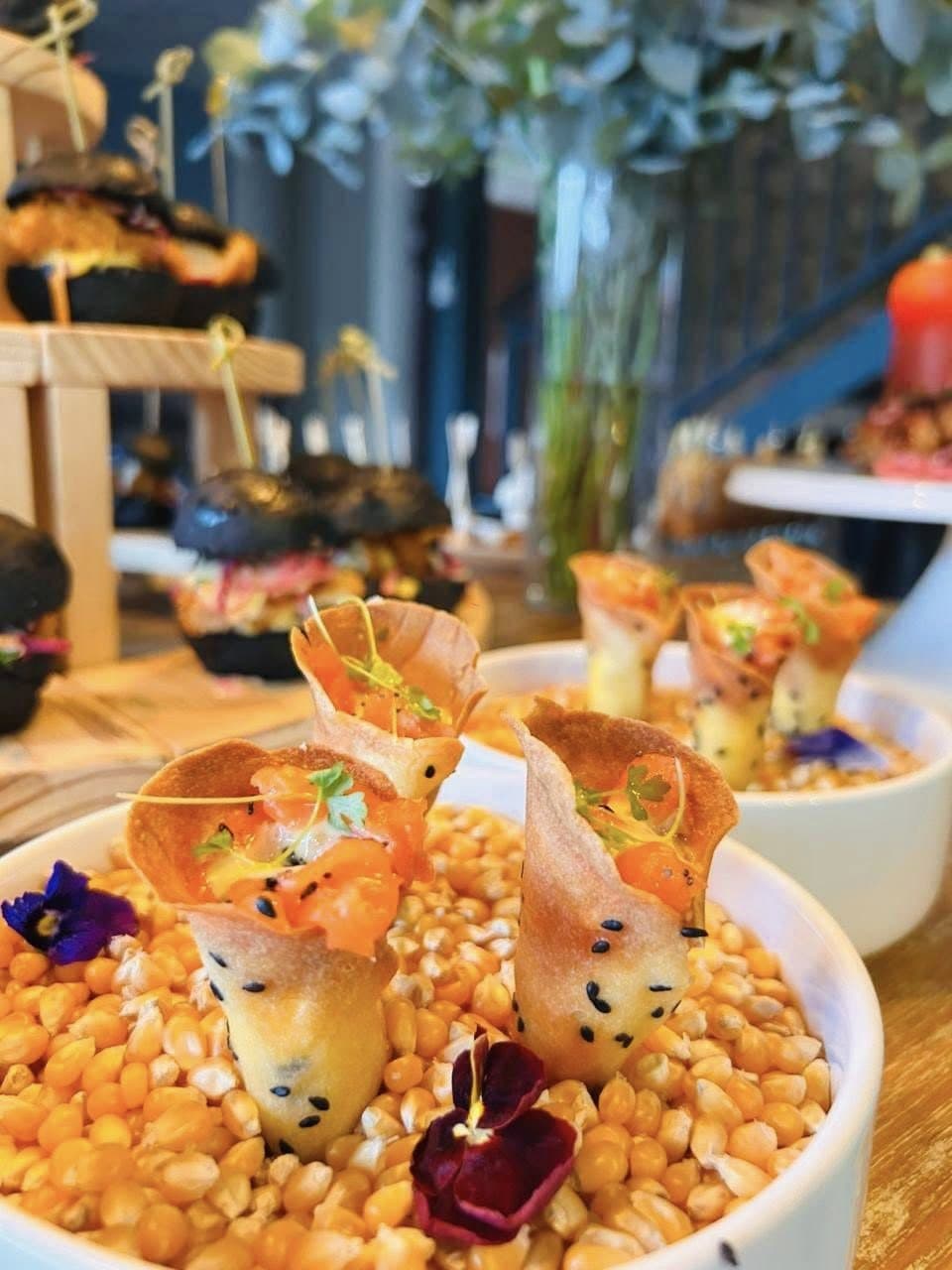 Crisp canapé cones presented in popcorn at an event