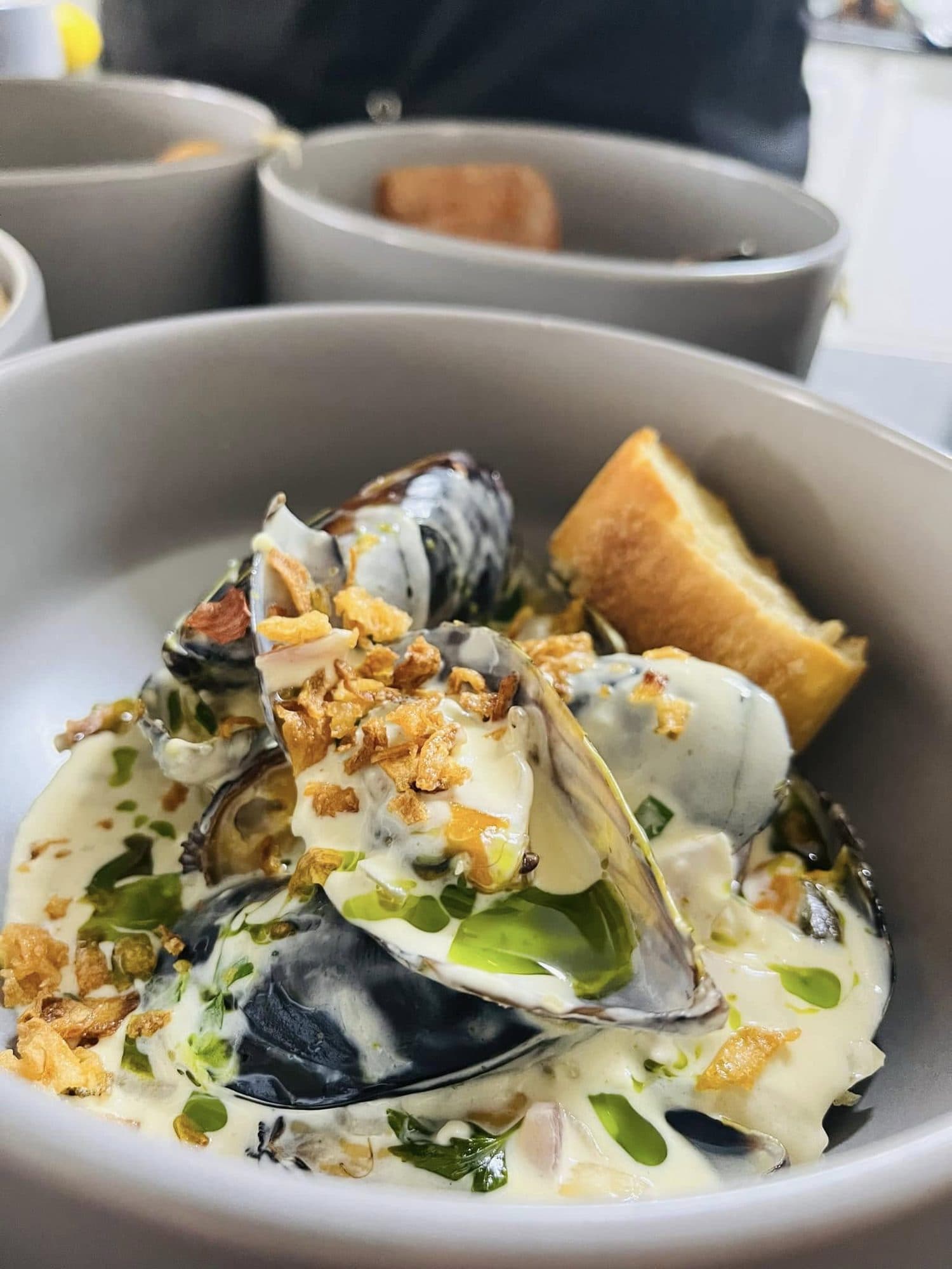Mussels in a creamy sauce with crunchy crumb and fresh herbs