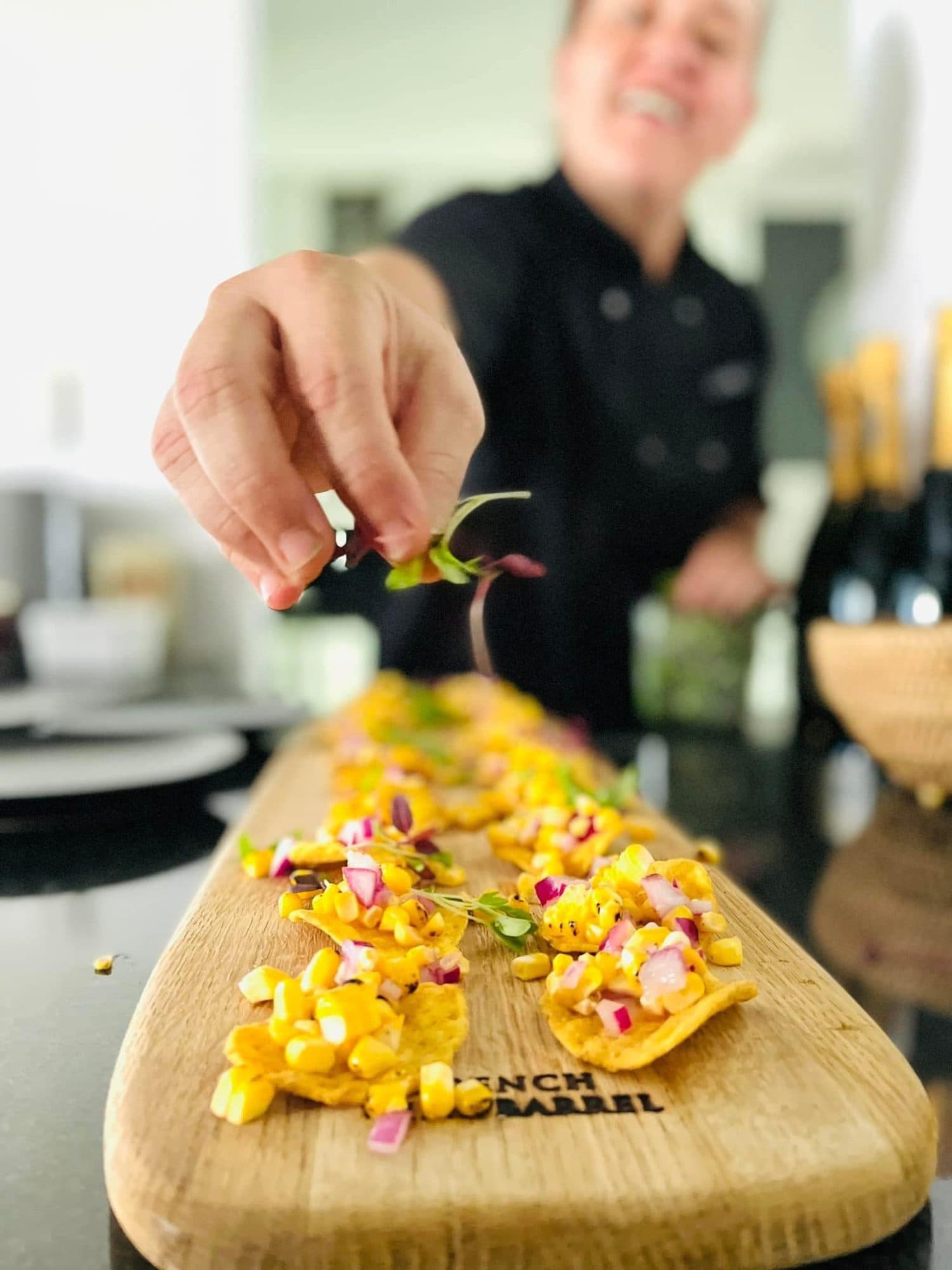 Finishing a board of mango salsa canapés
