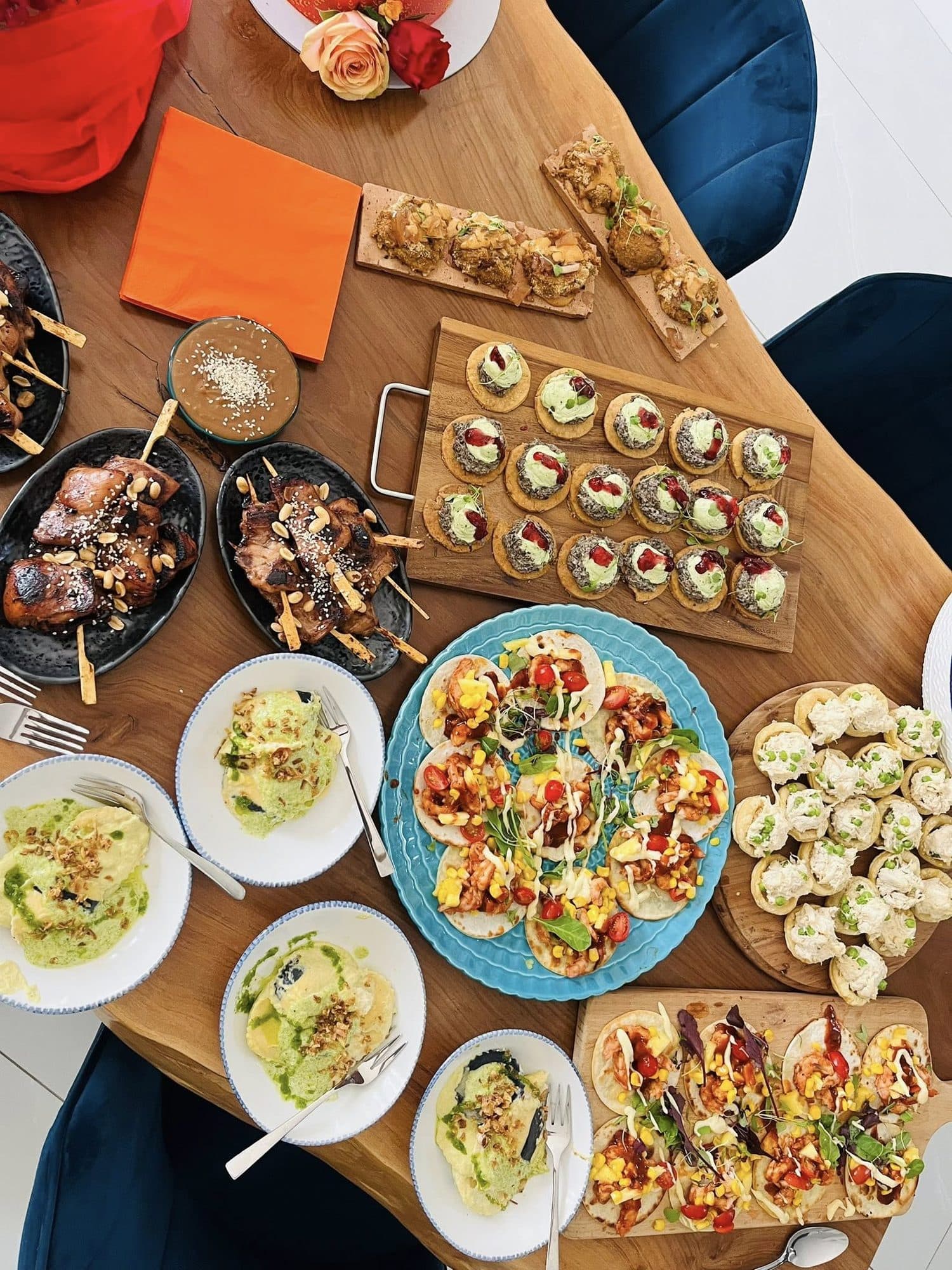 An abundant grazing table of canapés, tacos and small plates