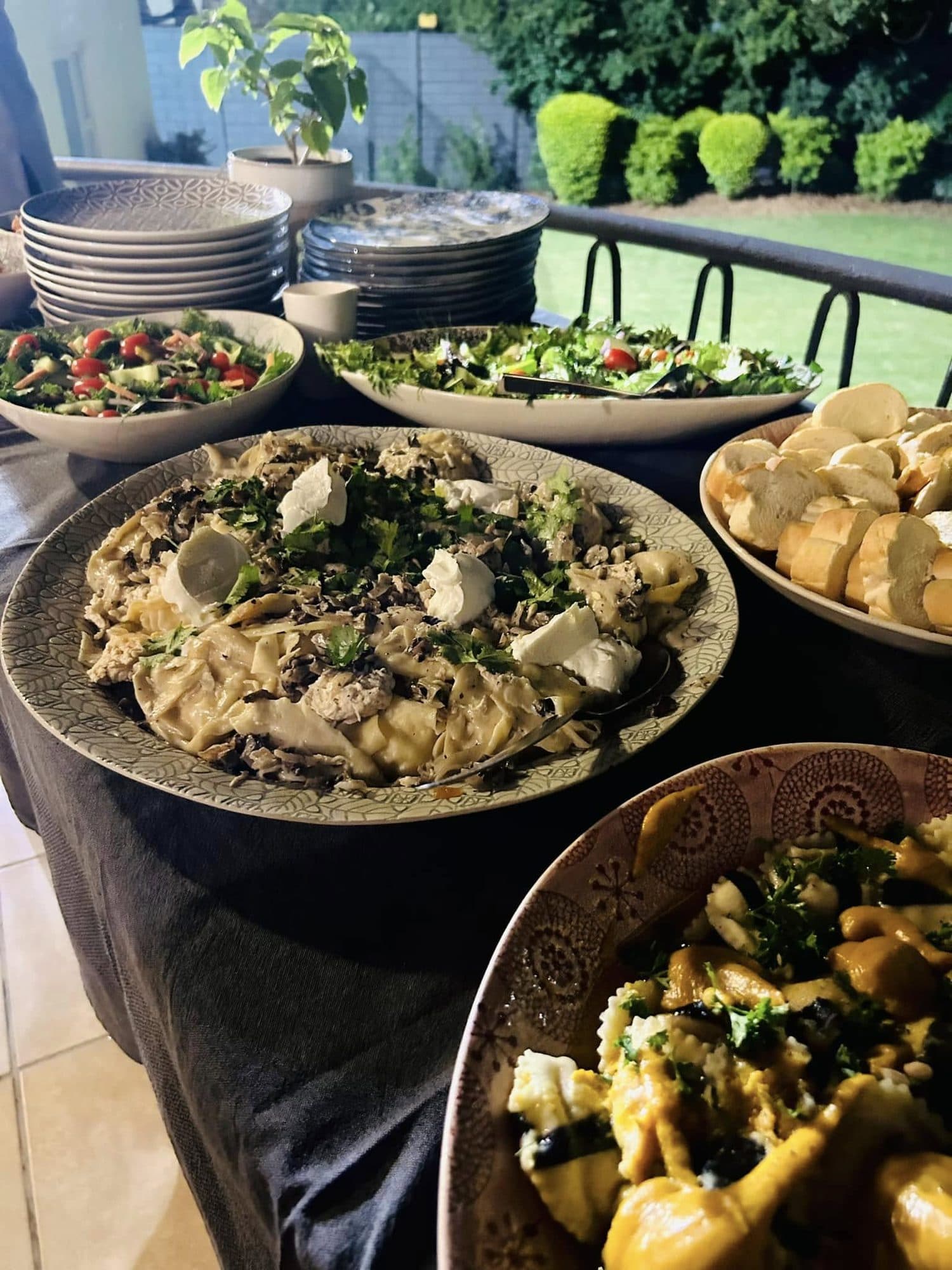 Outdoor buffet of fresh pasta and salads
