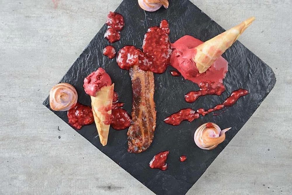 Raspberry dessert components arranged on a slate