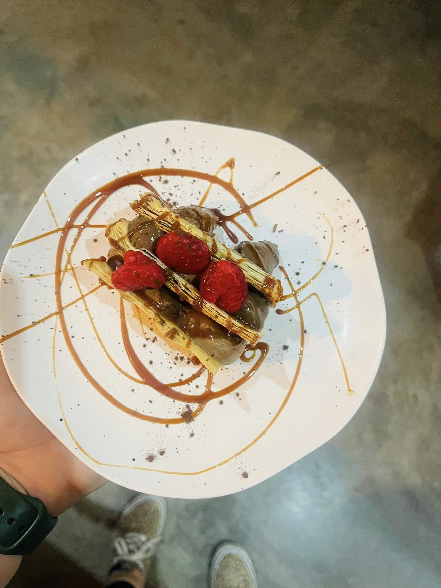 Layered dessert stack with strawberries and chocolate drizzle