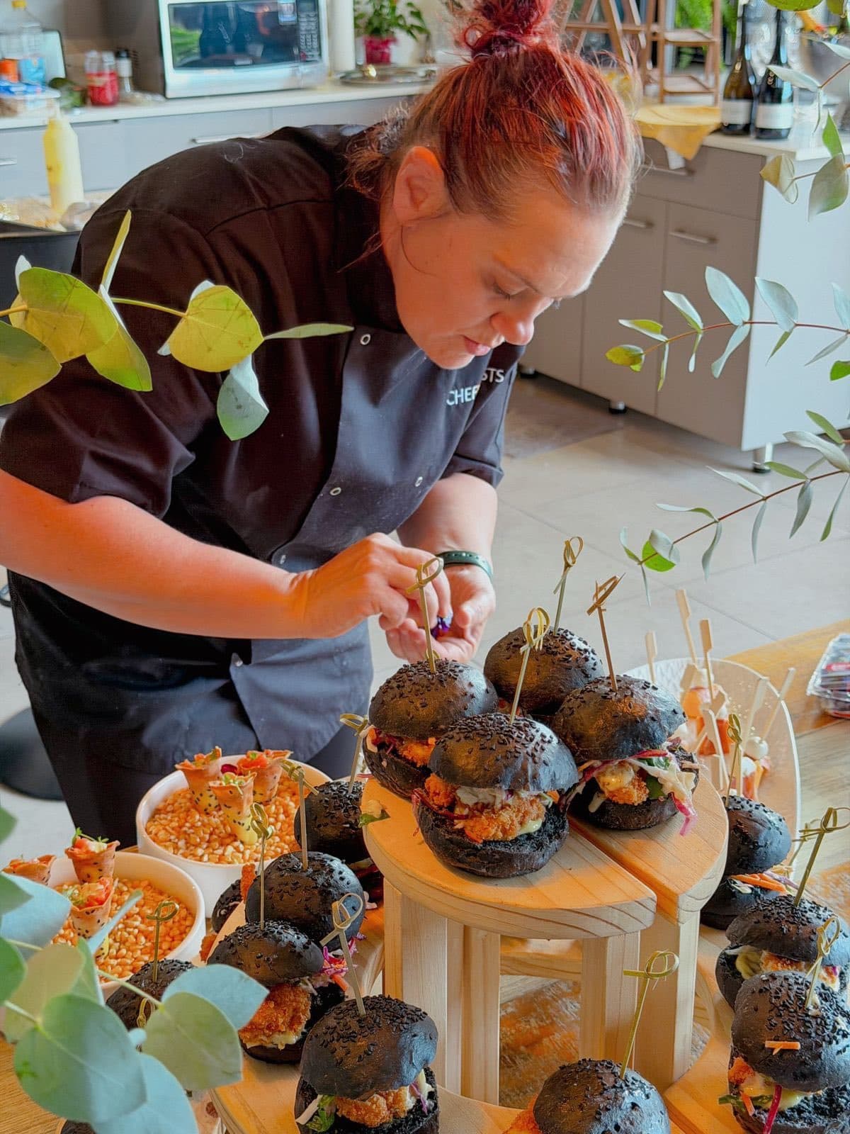 Chef Maradine assembling mini sliders on charcoal buns