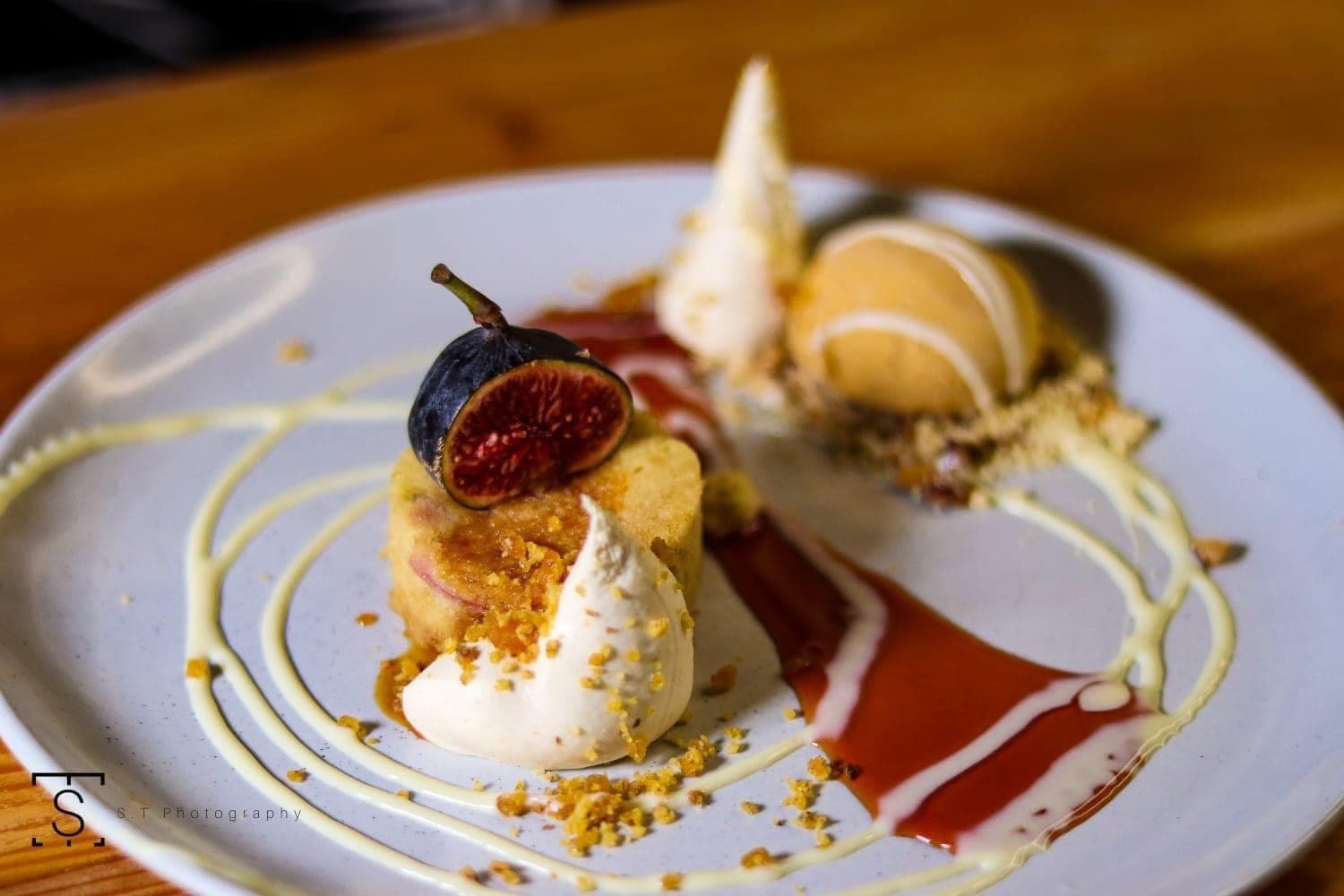 Fig dessert with cream, ice cream, crumb and berry coulis