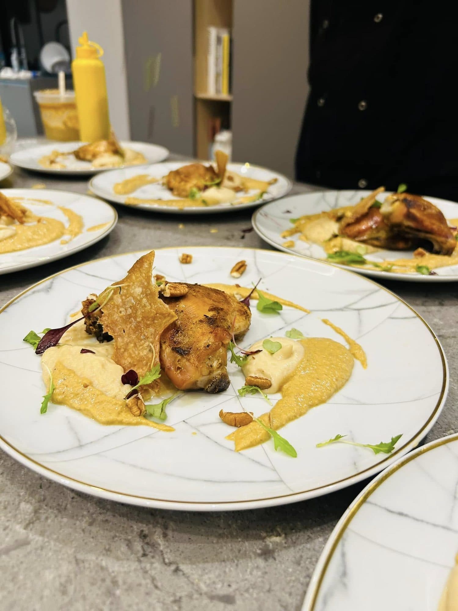 Plated roast with purée on gold-rimmed fine china